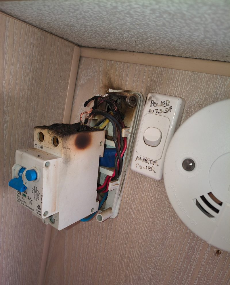 Before - scorched safety switch and melted wiring beside a smoke alarm